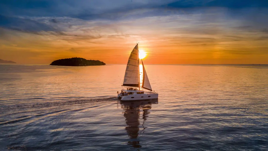 Catamaran sailing at sunset in Komodo National Park